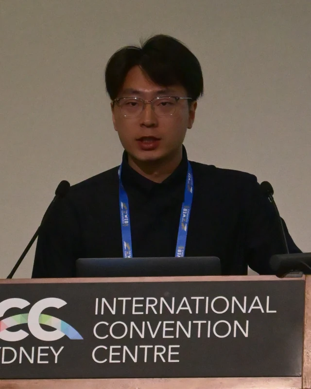 Yifei Cheng speaking at a conference in Sydney